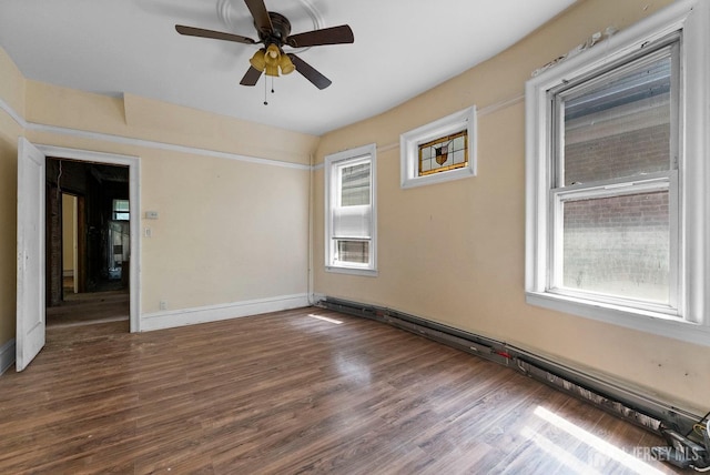 52 Wade St, Jersey City, NJ 07305 - unfurnished room featuring baseboard heating, healthy amount of natural light, ceiling fan, and wood finished floors