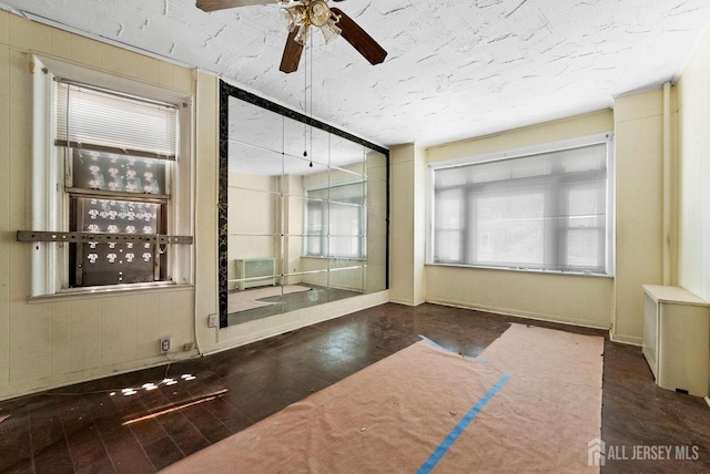 52 Wade St, Jersey City, NJ 07305 - unfurnished room featuring a ceiling fan, wood finished floors, and a textured ceiling