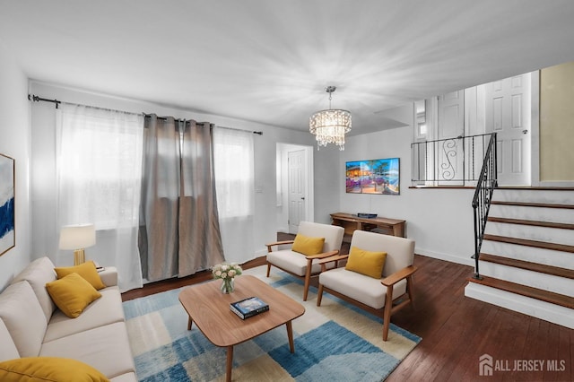 living room featuring dark wood-type flooring and a chandelier