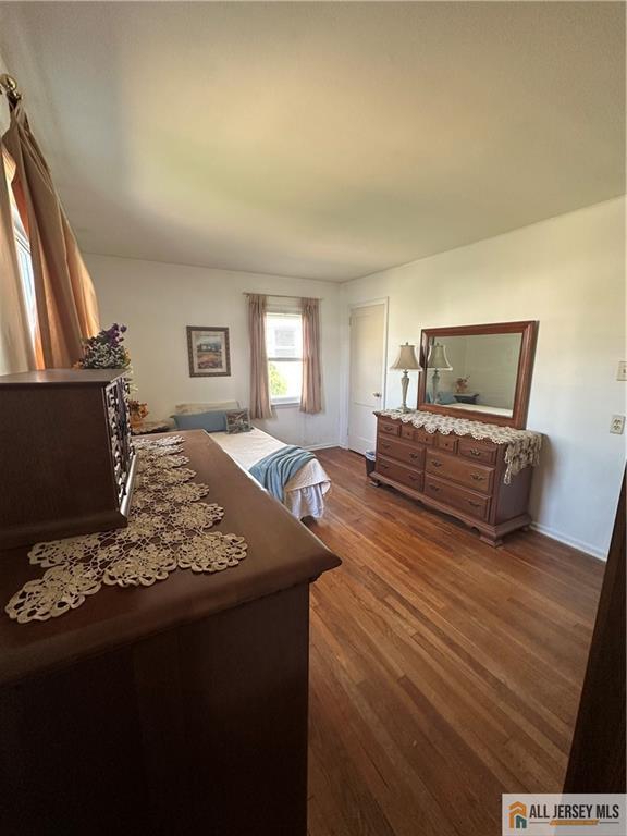 56 Harvey Cir E, Brunswick, NJ 08816 - bedroom featuring dark wood-type flooring and baseboards