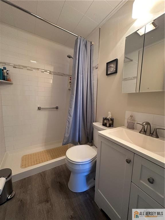 56 Harvey Cir E, Brunswick, NJ 08816 - full bath featuring wood finished floors, vanity, and a stall shower