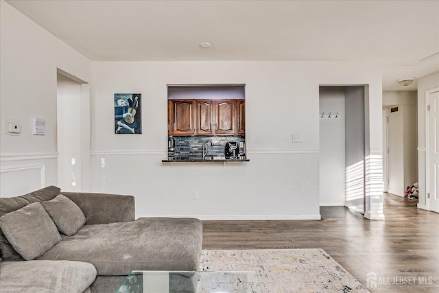 living area featuring baseboards and wood finished floors