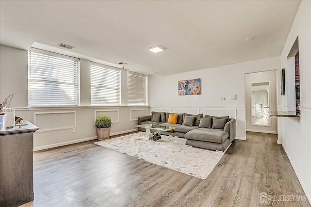 living room featuring wood finished floors and visible vents