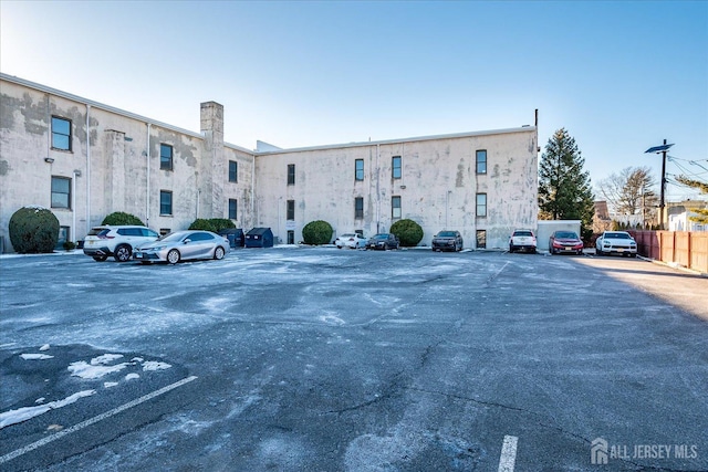 view of building exterior featuring uncovered parking