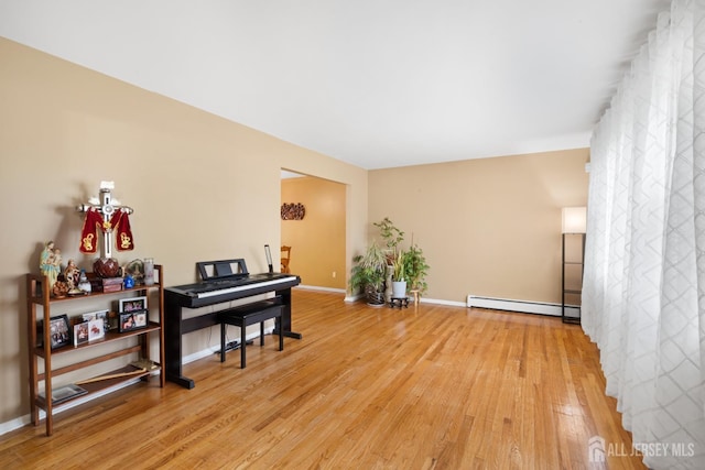 2001 Grant Ave, South Plainfield, NJ 07080 - living area with a baseboard heating unit and light wood finished floors