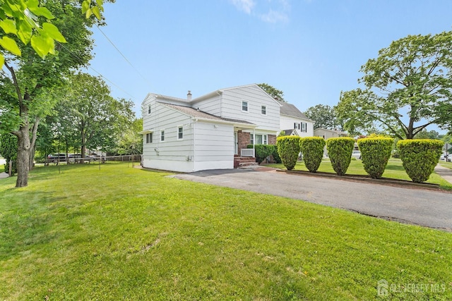 2001 Grant Ave, South Plainfield, NJ 07080 - view of side of home featuring a lawn, brick siding, and a chimney