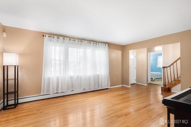 2001 Grant Ave, South Plainfield, NJ 07080 - unfurnished living room with baseboard heating, stairs, and wood finished floors
