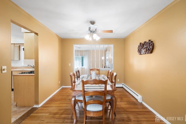 2001 Grant Ave, South Plainfield, NJ 07080 - dining area with a baseboard radiator, ceiling fan, and wood finished floors
