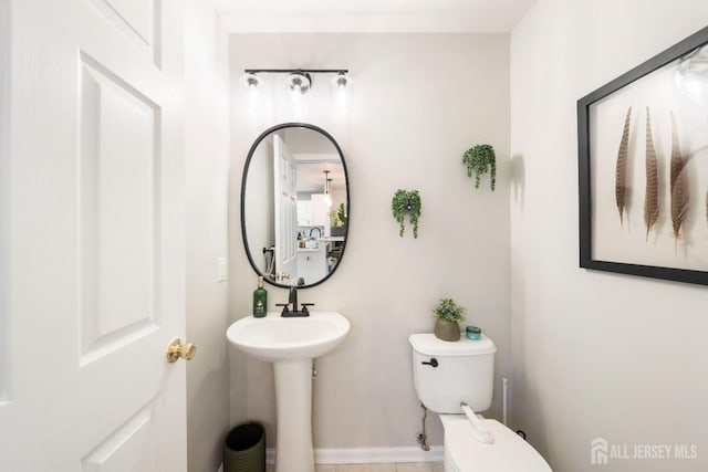 bathroom with toilet and a sink