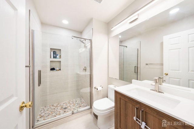 full bathroom featuring vanity, a shower stall, toilet, and recessed lighting