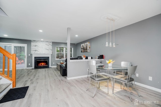 324 Oak Knoll Dr, Manalapan, NJ 07726 - dining room featuring wood finished floors, a large fireplace, stairway, and recessed lighting