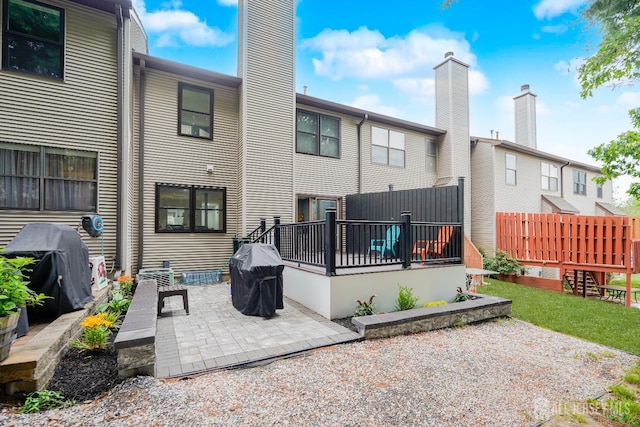 324 Oak Knoll Dr, Manalapan, NJ 07726 - rear view of property with a patio area, a chimney, and a wooden deck