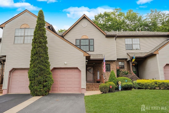 324 Oak Knoll Dr, Manalapan, NJ 07726 - view of front facade with a front lawn, driveway, and brick siding