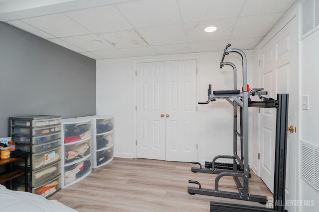 324 Oak Knoll Dr, Manalapan, NJ 07726 - workout area featuring a drop ceiling and wood finished floors