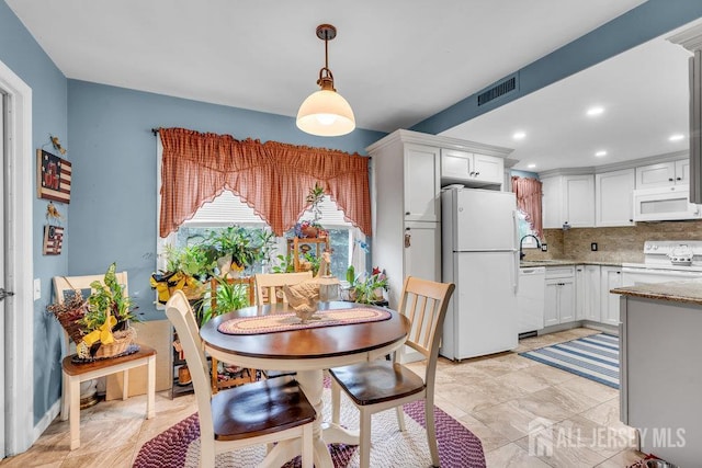 dining space featuring recessed lighting
