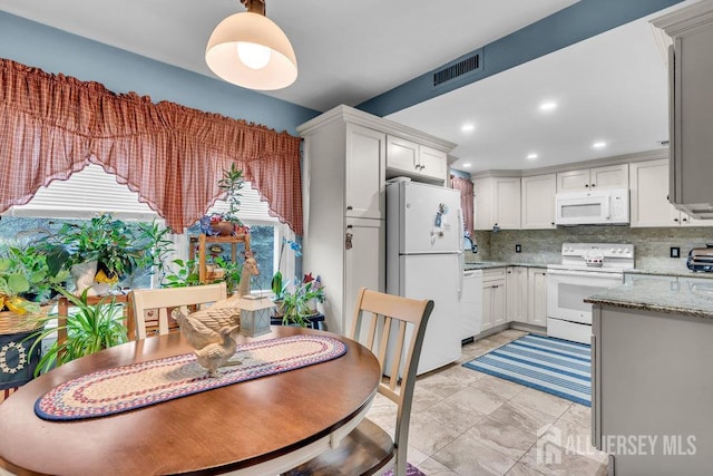 dining area featuring recessed lighting