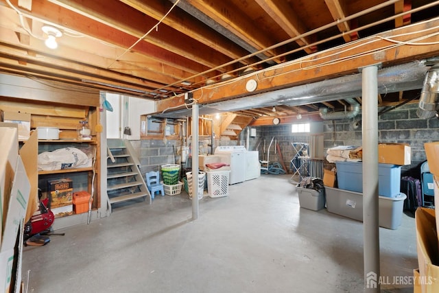basement featuring washer and clothes dryer and stairs