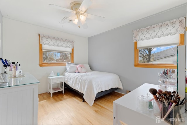 bedroom with light wood-style floors and a ceiling fan