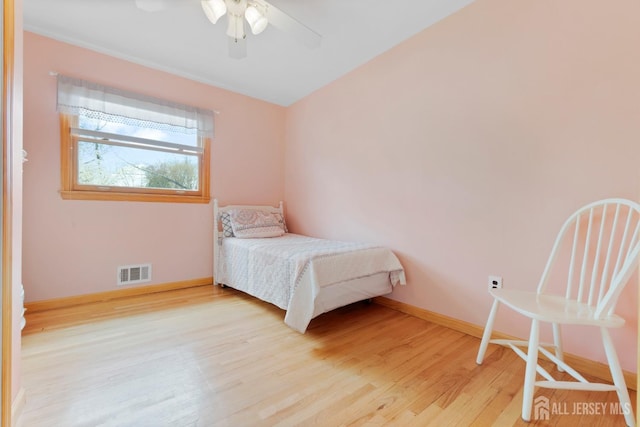 bedroom with wood finished floors, baseboards, and ceiling fan