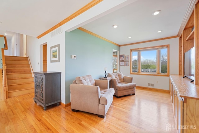 sitting room with crown molding, light wood finished floors, baseboards, stairway, and recessed lighting