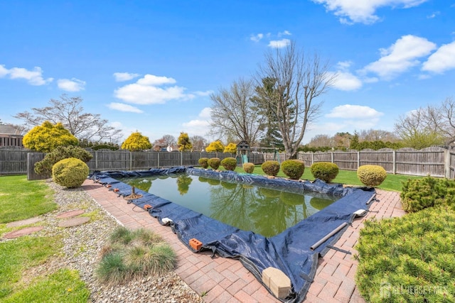 view of pool with a fenced backyard