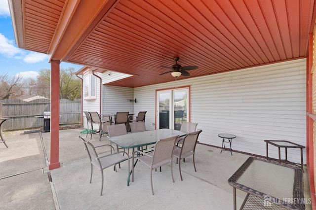 view of patio / terrace featuring outdoor dining space, ceiling fan, fence, and grilling area