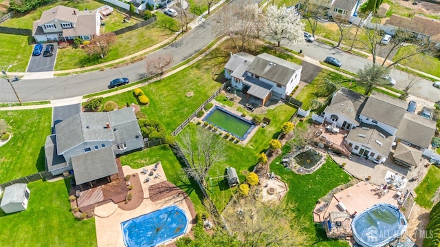 aerial view of property and surrounding area with nearby suburban area and a pool area