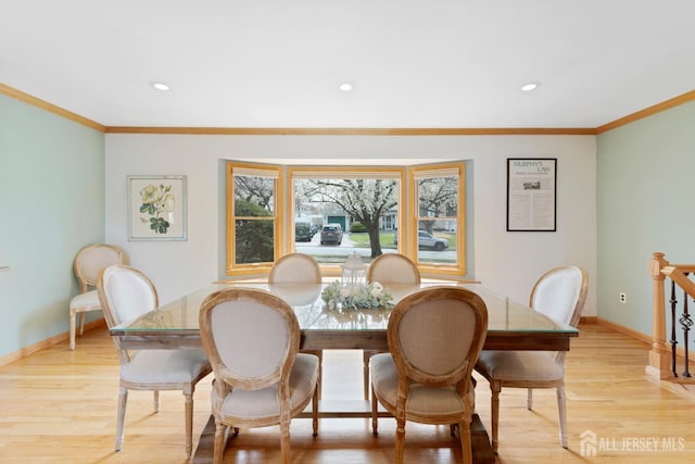 dining room with baseboards, light wood-type flooring, ornamental molding, and recessed lighting