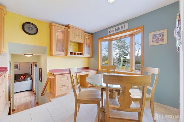 dining room with baseboards and light tile patterned floors
