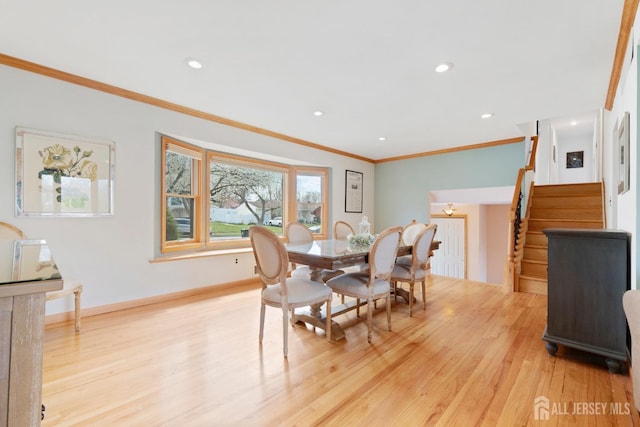 dining room featuring stairs, light wood-style flooring, crown molding, recessed lighting, and baseboards