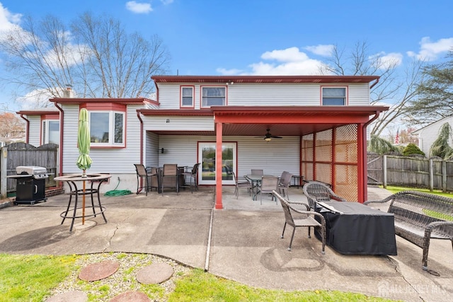 back of house featuring ceiling fan, outdoor dining space, fence, and a patio area