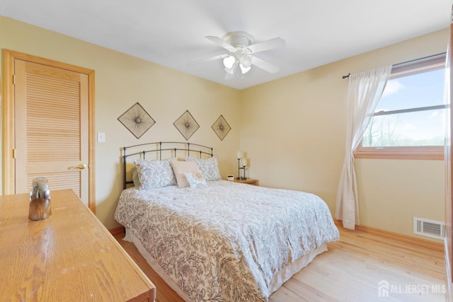 bedroom with wood finished floors, baseboards, and ceiling fan