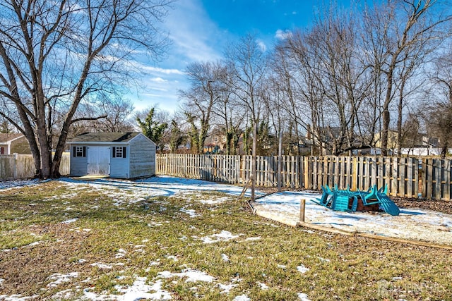 snowy yard featuring a storage shed