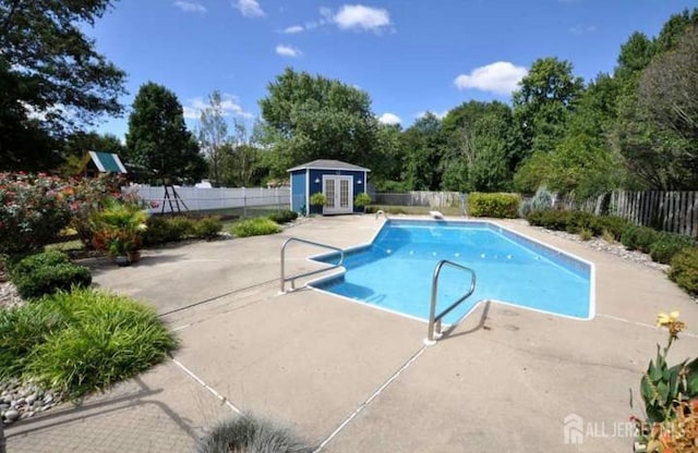 view of pool with an outdoor structure and a patio area