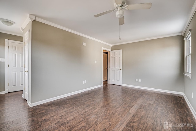 spare room featuring dark hardwood / wood-style flooring, ornamental molding, and ceiling fan