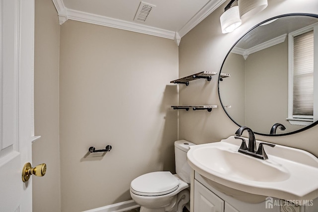 bathroom with vanity, ornamental molding, and toilet