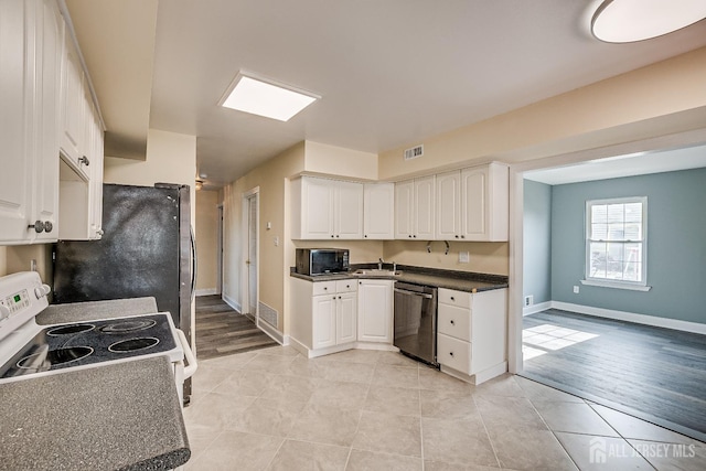 kitchen with white cabinetry, appliances with stainless steel finishes, sink, and light tile patterned flooring