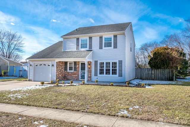 view of front property featuring a garage and a front yard