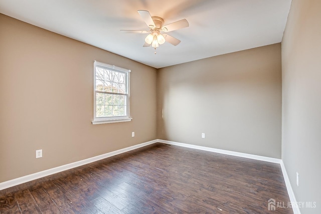 empty room with dark wood-type flooring and ceiling fan