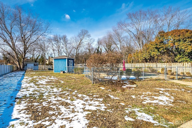 yard covered in snow with a shed