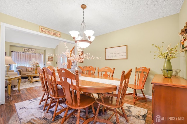 40 Nathan Dr, Old Bridge, NJ 08857 - dining area featuring a chandelier, a textured ceiling, and wood finished floors