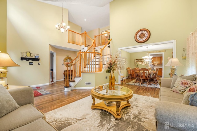40 Nathan Dr, Old Bridge, NJ 08857 - living area with a chandelier, high vaulted ceiling, wood finished floors, and stairs