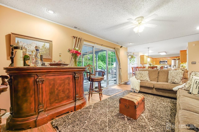 40 Nathan Dr, Old Bridge, NJ 08857 - living room with light wood-type flooring, a textured ceiling, ceiling fan, crown molding, and a dry bar