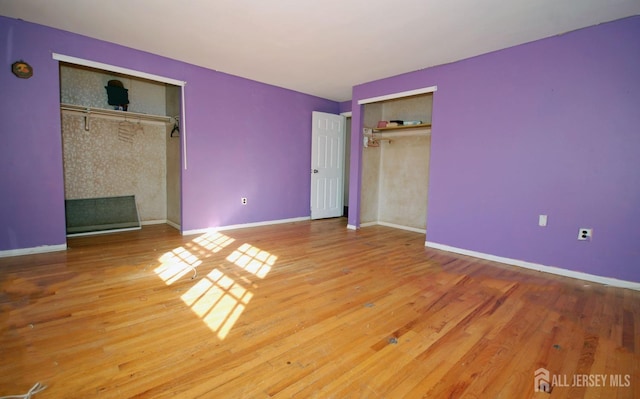 unfurnished bedroom with hardwood / wood-style floors and a closet