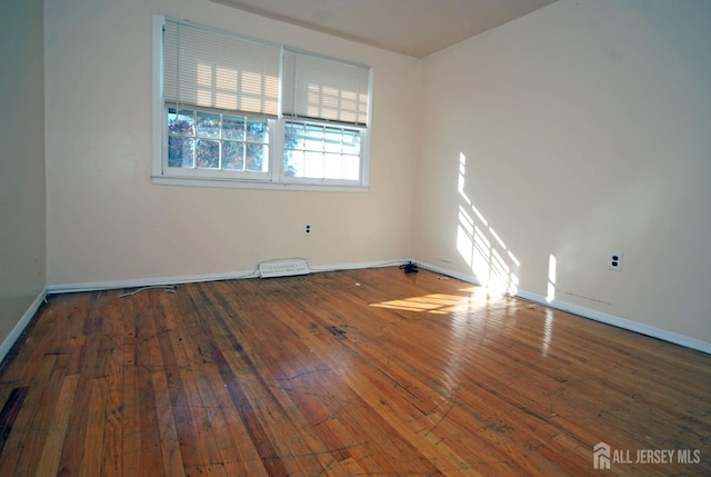 spare room with wood-type flooring