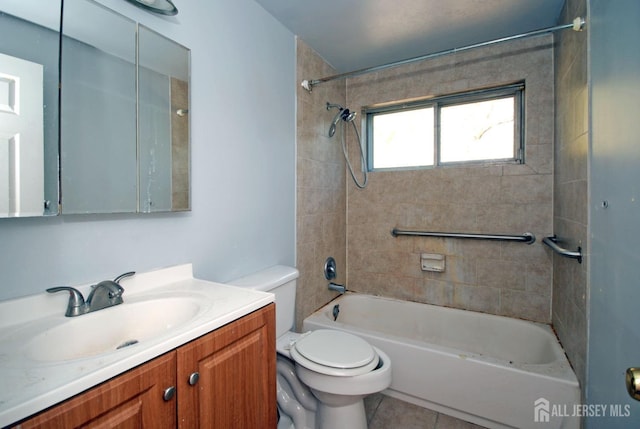 full bathroom with tile patterned flooring, vanity, toilet, and tiled shower / bath