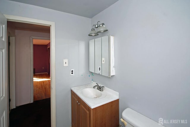 bathroom featuring vanity and toilet