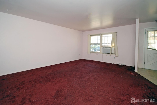 carpeted spare room with cooling unit and a healthy amount of sunlight