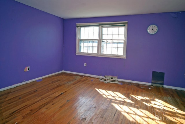 spare room with hardwood / wood-style floors