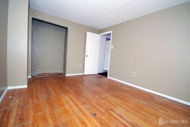 unfurnished bedroom featuring hardwood / wood-style flooring